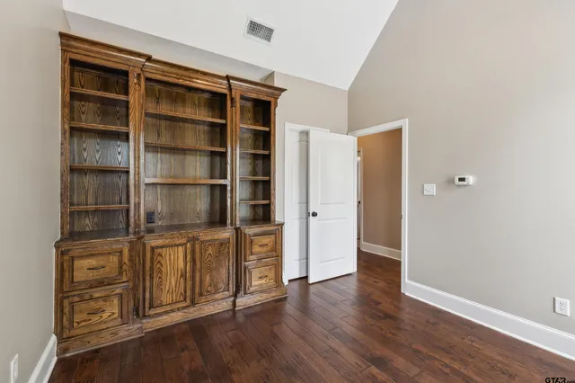 a view of an empty room with empty shelves