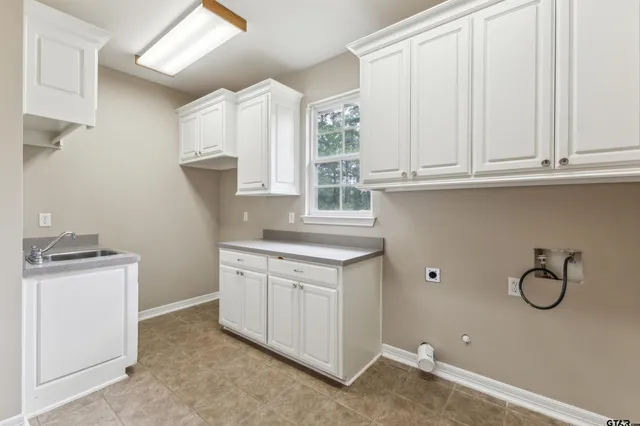 a kitchen with granite countertop white cabinets and a stove