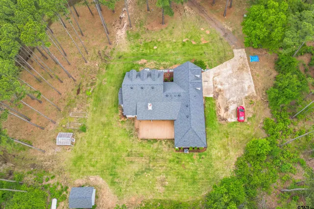 an aerial view of residential house with pool and garden