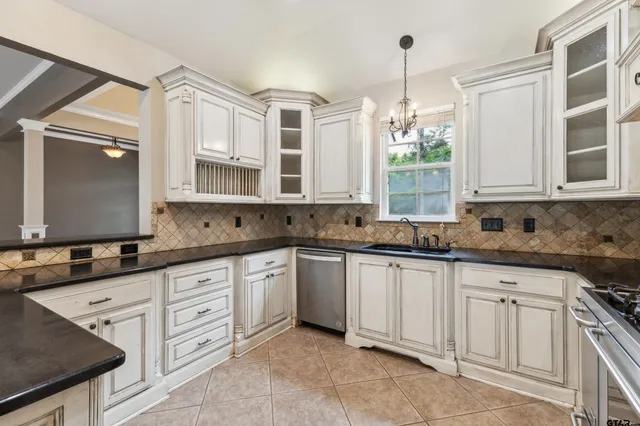 a kitchen with stainless steel appliances granite countertop a sink and a stove