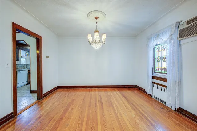 a view of a room with wooden floor window and a mirror