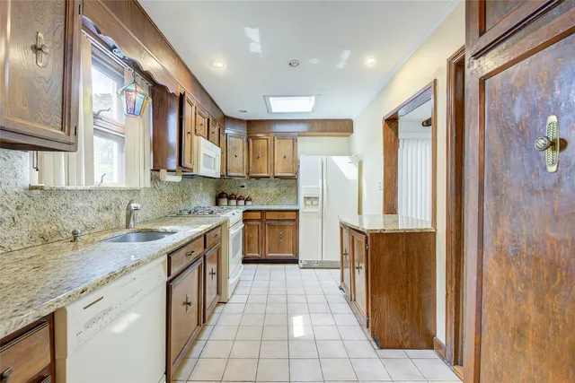 a kitchen with stainless steel appliances granite countertop a refrigerator and a sink