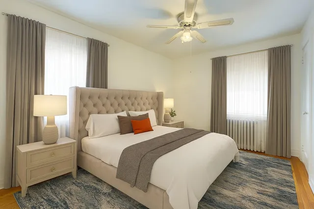 a bedroom with a white bed and a chandelier