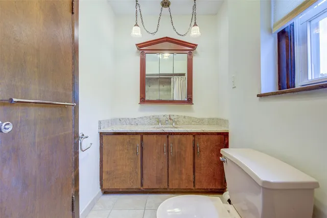 a bathroom with a sink a toilet and mirror