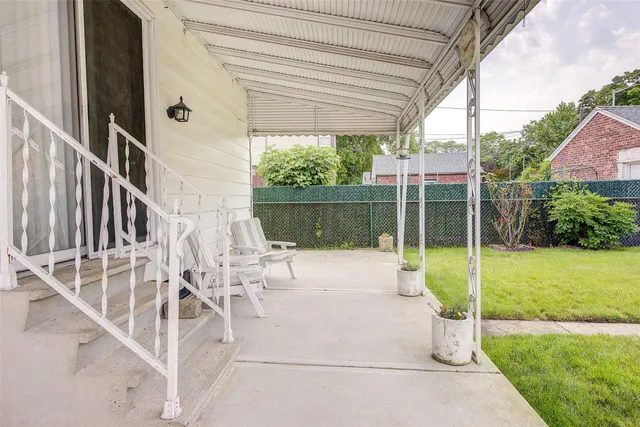 a white bench sitting in front of a house