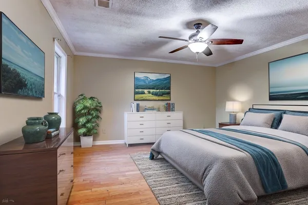 a bedroom with a bed and ceiling fan