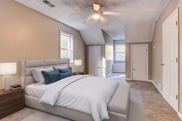 a bedroom with bed and window