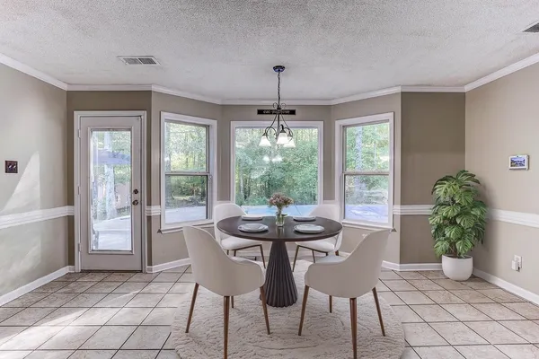 a dining room with furniture window and outside view