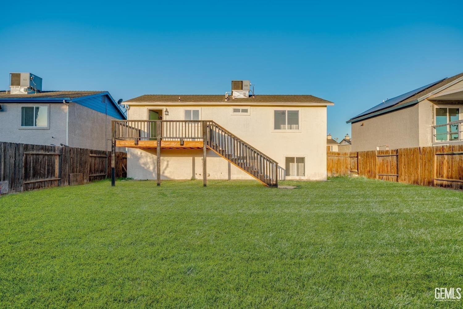 Undisclosed Address Bakersfield, CA 93307 - Photo 13 of 14 a view of a house with a back yard