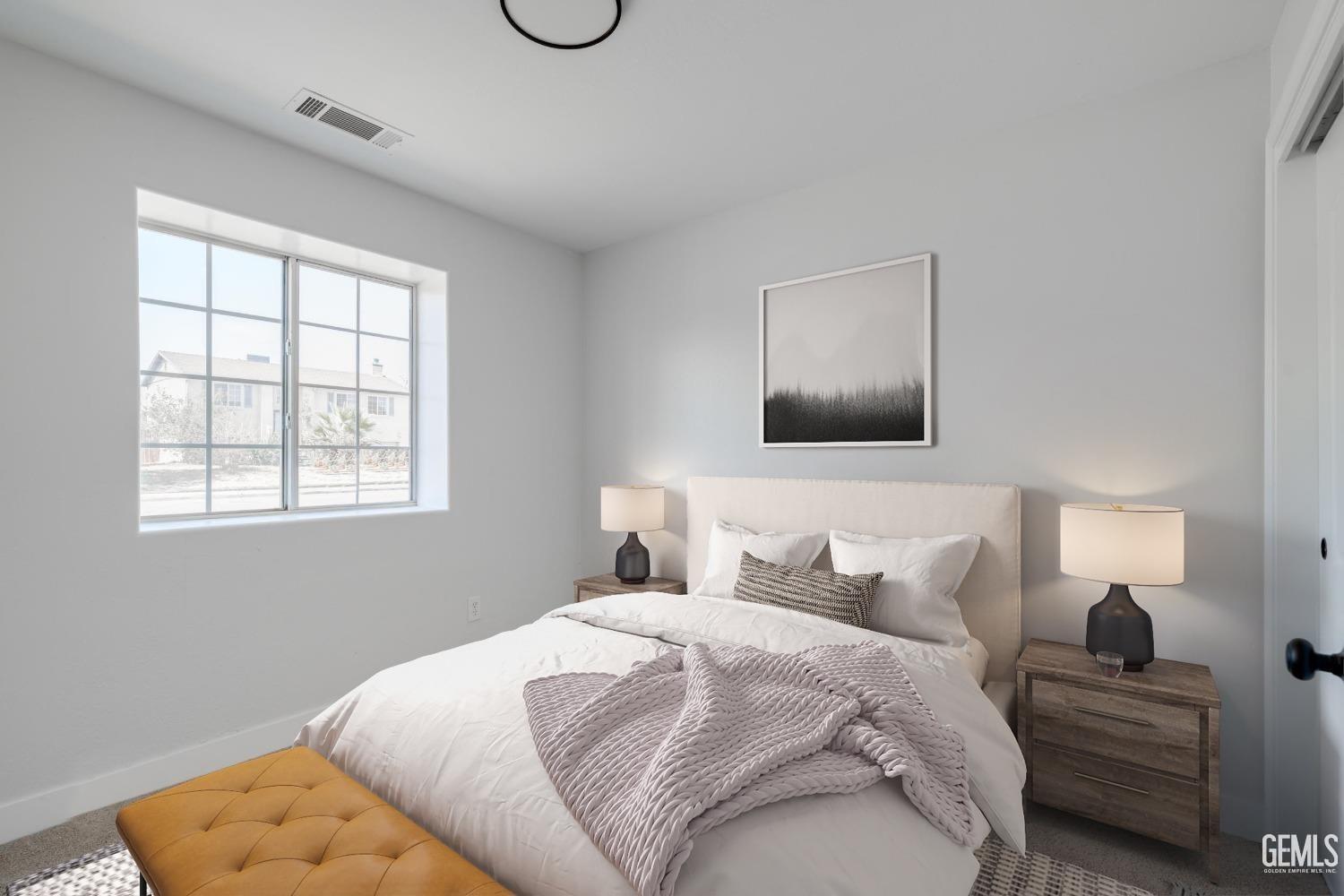 Undisclosed Address Bakersfield, CA 93307 - Photo 7 of 14 a bedroom with a bed and a lamp with window
