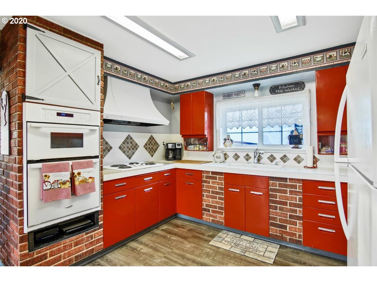 37161 Southeast Trubel Road Sandy, OR 97055 - Photo 11 of 27 a kitchen with stainless steel appliances granite countertop a sink and wooden cabinets