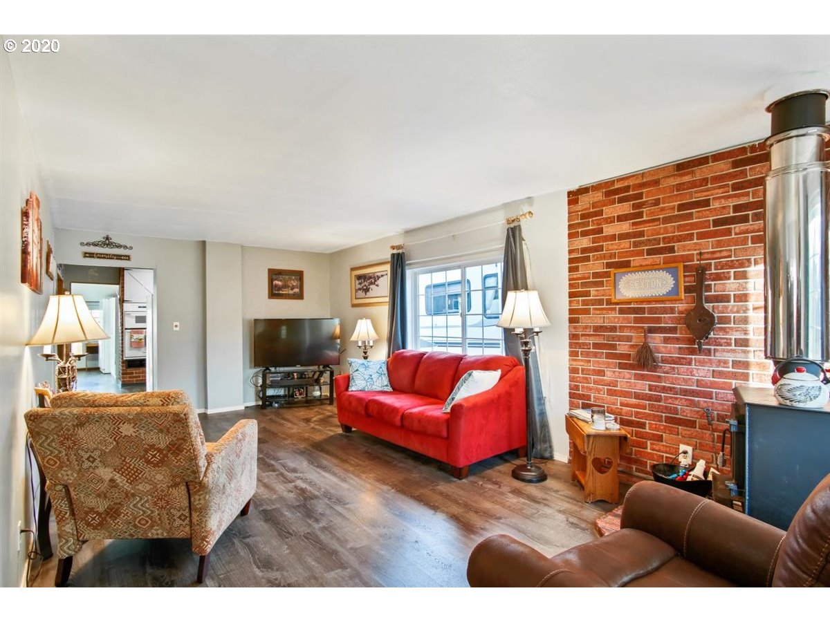 37161 Southeast Trubel Road Sandy, OR 97055 - Photo 7 of 27 a living room with furniture windows and a flat screen tv