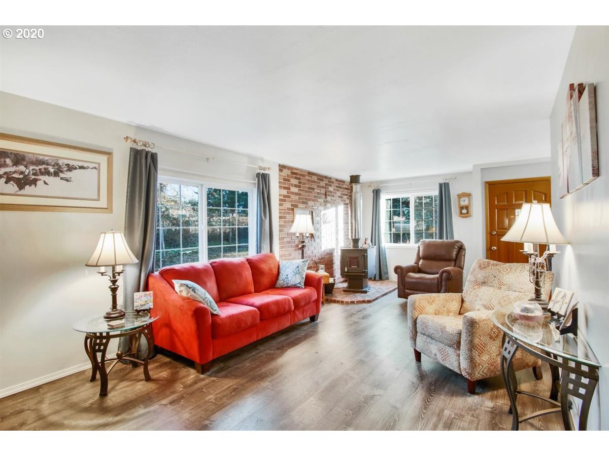 37161 Southeast Trubel Road Sandy, OR 97055 - Photo 9 of 27 a living room with furniture a rug and a large window