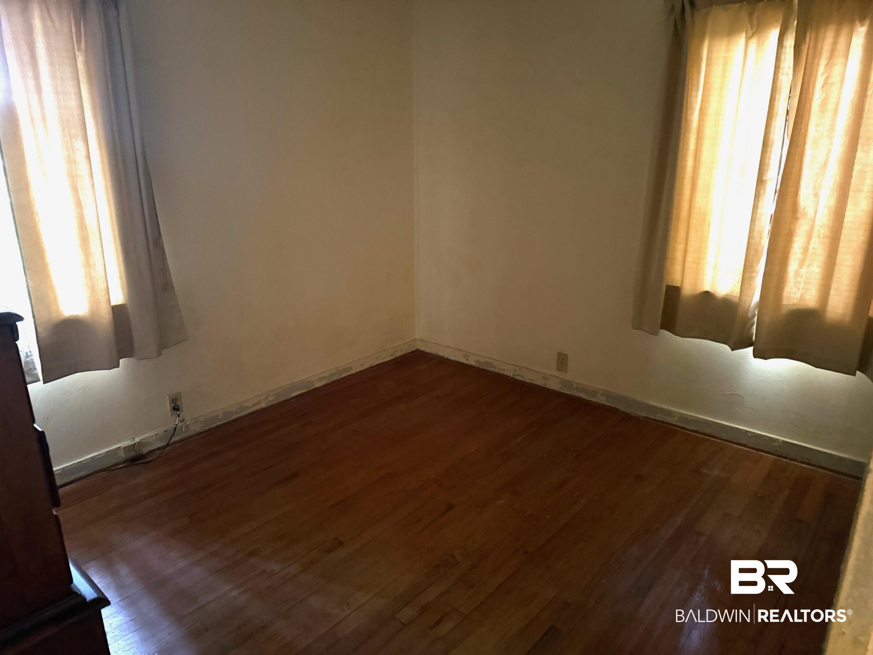 156 Pier Avenue Fairhope, AL 36532 - Photo 23 of 41 Unfurnished room with dark wood finished floors