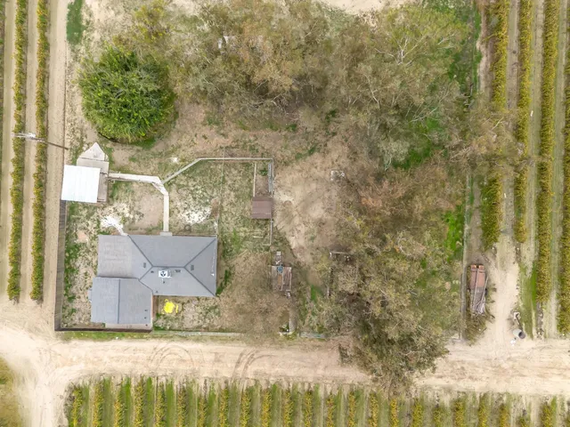 a kitchen with stainless steel appliances a sink a stove a refrigerator cabinets and dining table