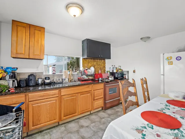 a view of a yard in front of a house with large tree