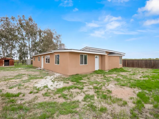 a kitchen with granite countertop a sink stainless steel appliances and cabinets