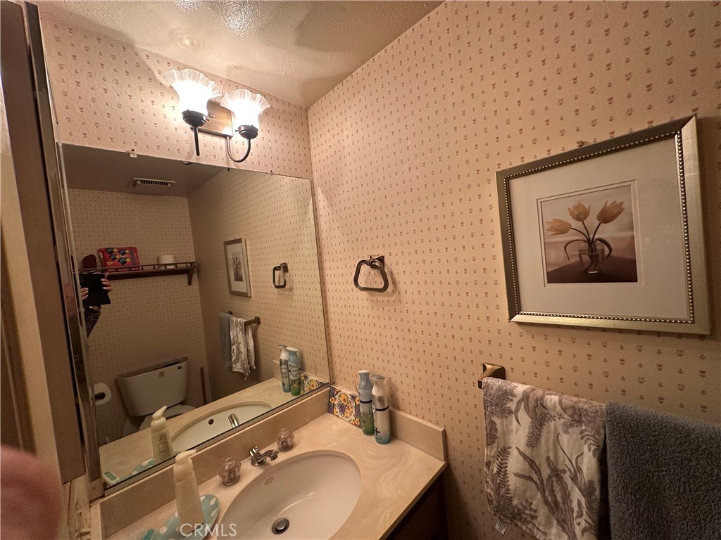 10451 Mulhall Street, Unit 25 El Monte, CA 91731 - Photo 12 of 21 a bathroom with a sink mirror and vanity