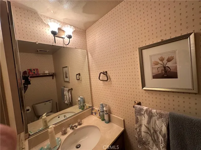 a bathroom with a sink mirror and vanity