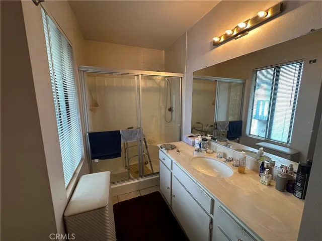 a bathroom with a sink a mirror and a shower