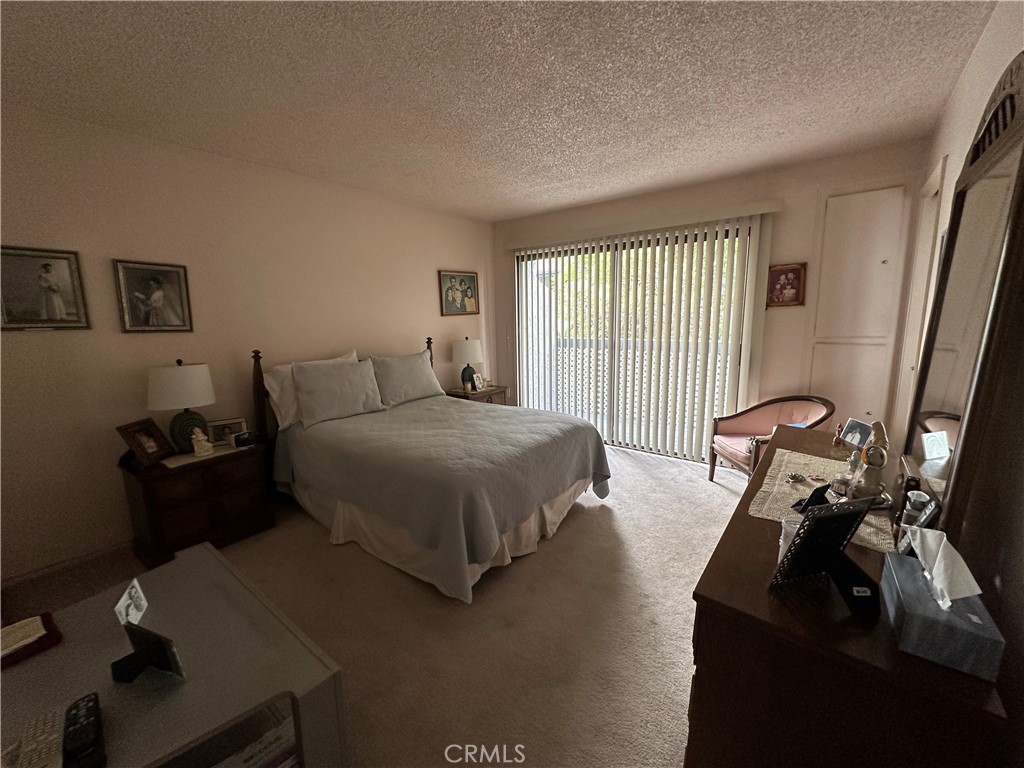10451 Mulhall Street, Unit 25 El Monte, CA 91731 - Photo 19 of 21 a bedroom with bed chair and window