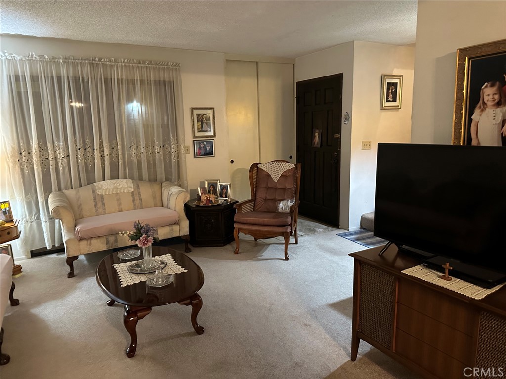 10451 Mulhall Street, Unit 25 El Monte, CA 91731 - Photo 5 of 21 a living room with furniture and a flat screen tv