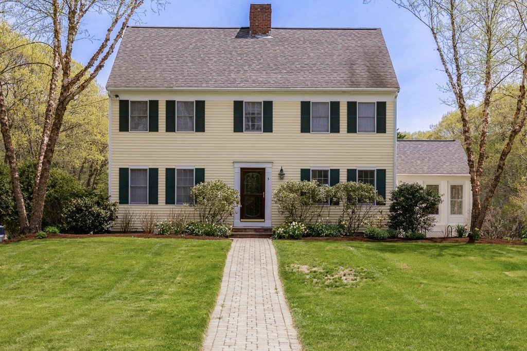 a front view of house with yard and green space
