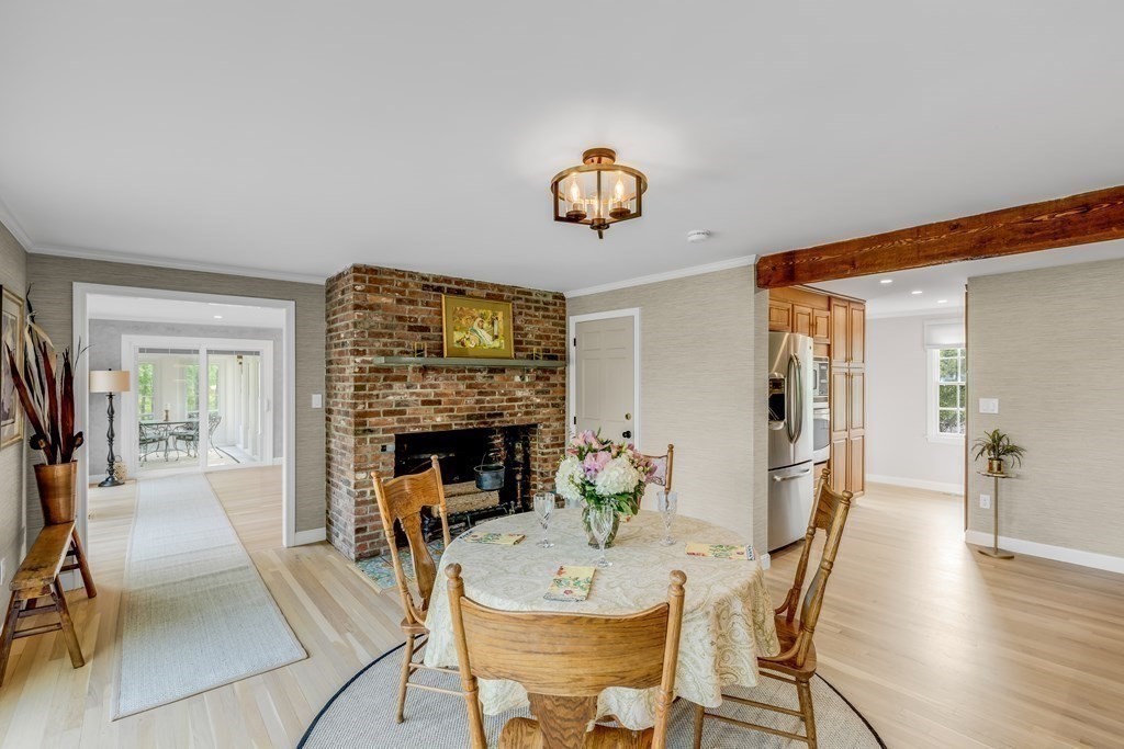 3 Longmeadow Way Hamilton, MA 01982 - Photo 14 of 41 a view of a dining room with furniture wooden floor and a fireplace