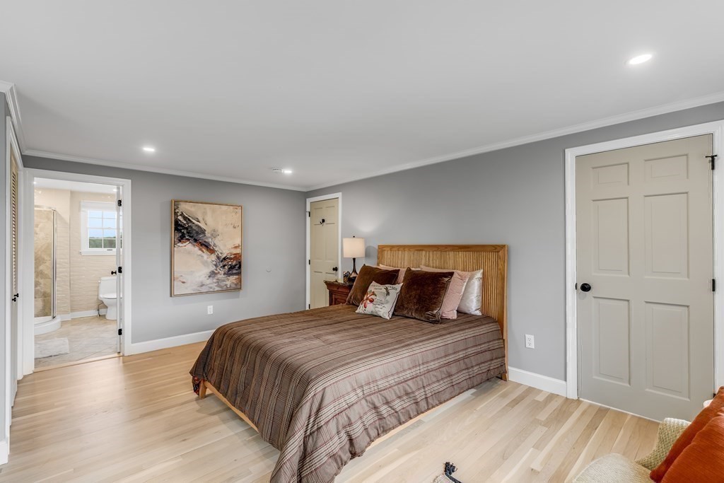 3 Longmeadow Way Hamilton, MA 01982 - Photo 19 of 41 a bedroom with a large bed and a painting on the wall