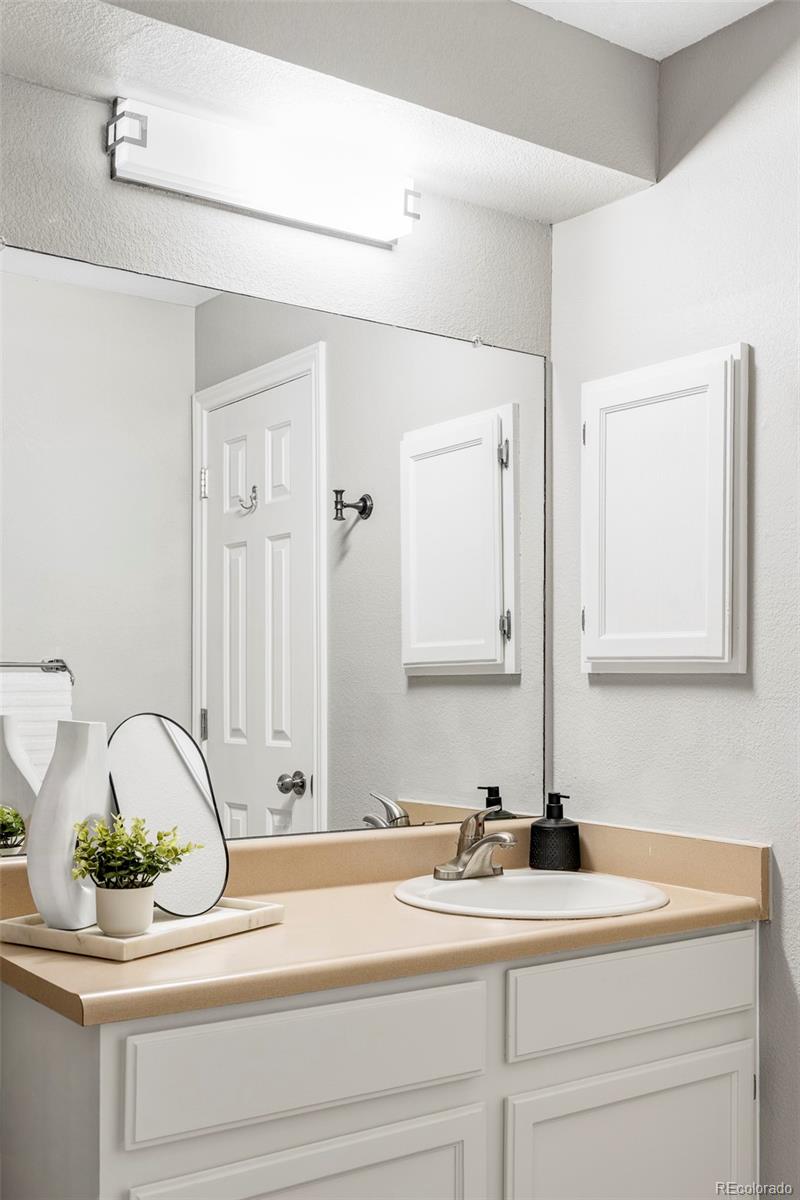 862 South Reed Court, Unit J Lakewood, CO 80226 - Photo 17 of 37 a bathroom with a sink and a mirror