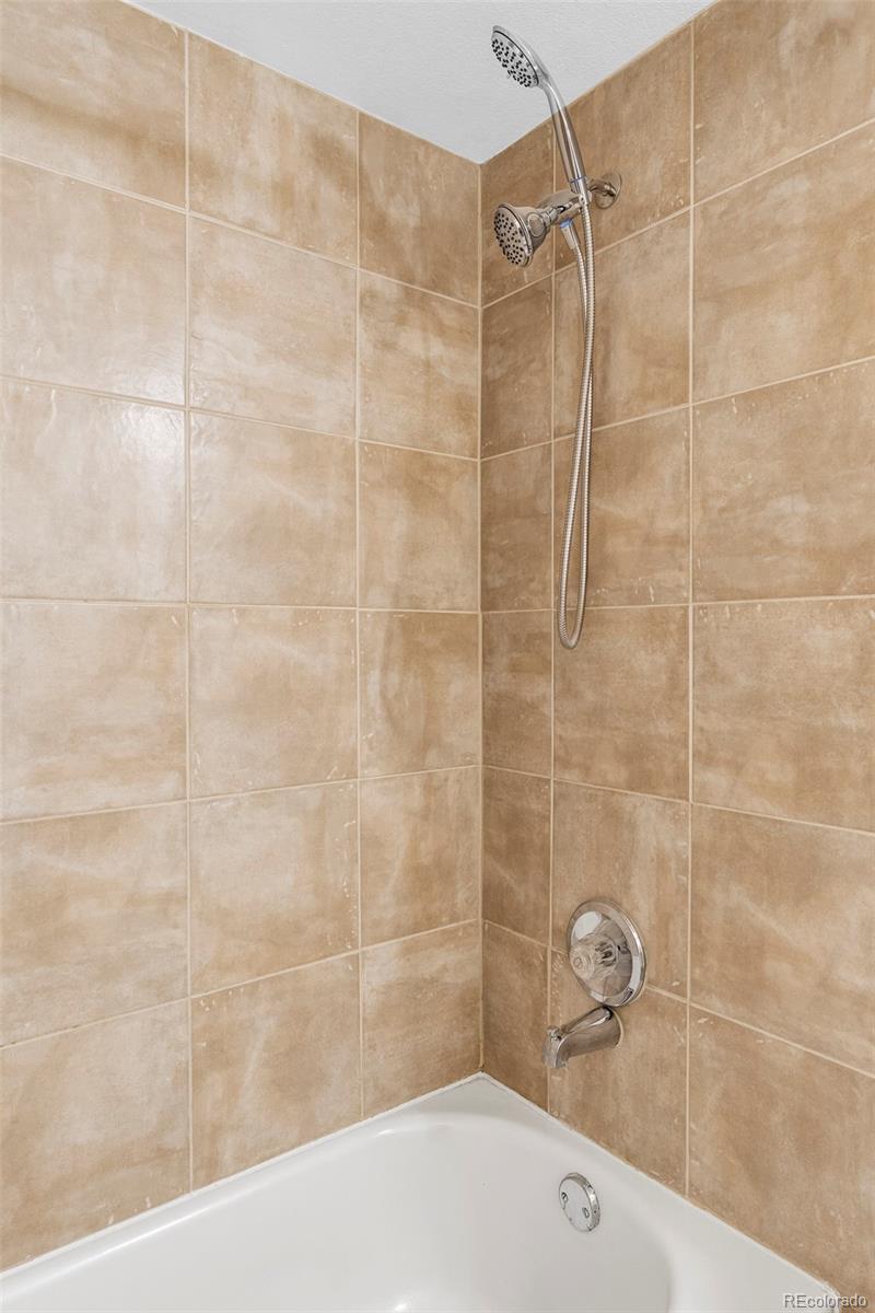 862 South Reed Court, Unit J Lakewood, CO 80226 - Photo 18 of 37 a bathroom with a shower and a sink