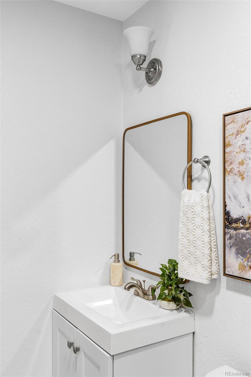 862 South Reed Court, Unit J Lakewood, CO 80226 - Photo 24 of 37 a bathroom with a sink and mirror