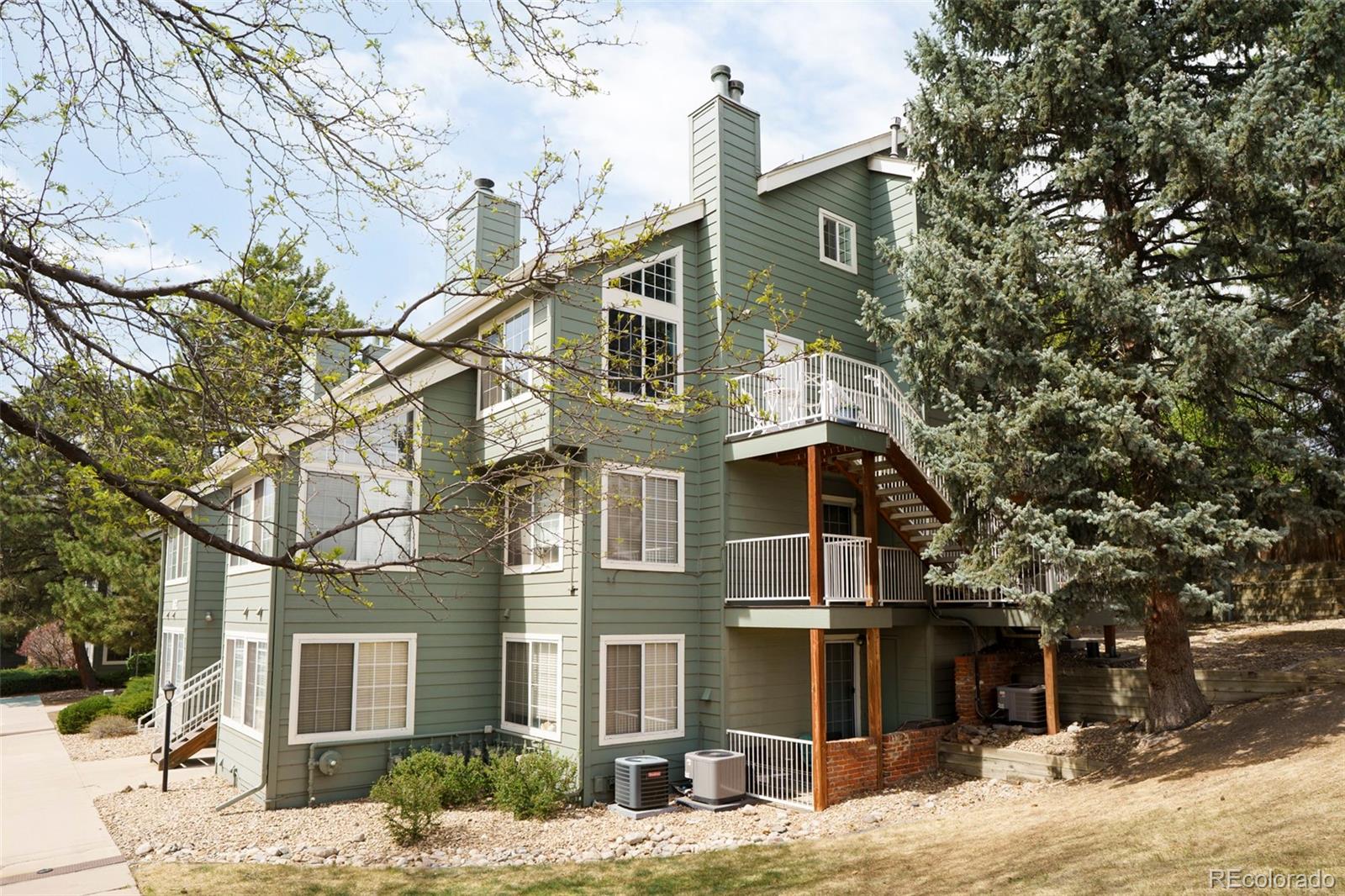 862 South Reed Court, Unit J Lakewood, CO 80226 - Photo 26 of 37 a view of a white house with a large tree