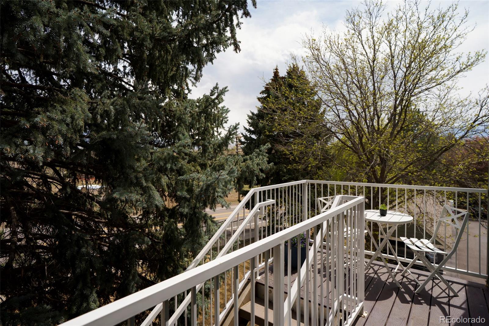 862 South Reed Court, Unit J Lakewood, CO 80226 - Photo 27 of 37 a view of balcony with wooden floor and fence