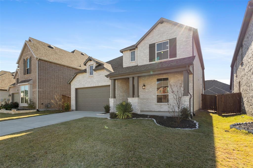 a view of a brick house next to a yard