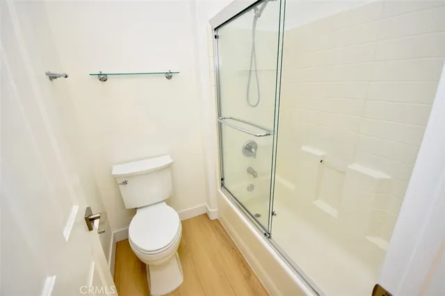 a bathroom with a toilet and shower