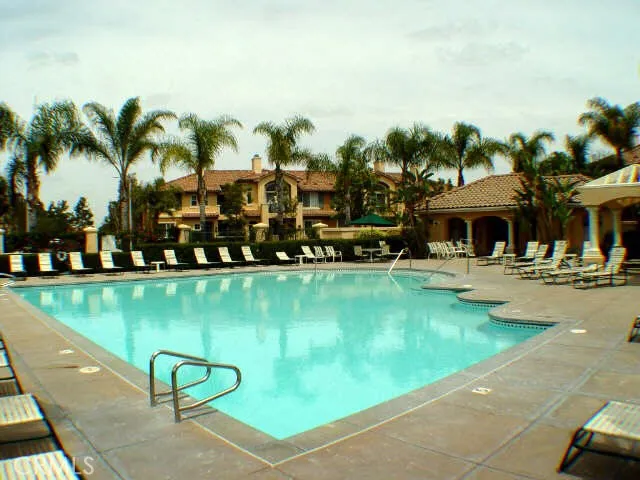 a view of swimming pool with outdoor seating and lake