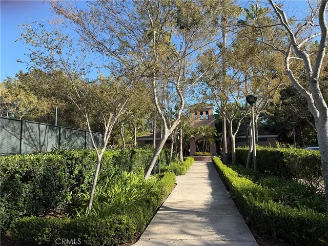 a view of a pathway with a wrought fence