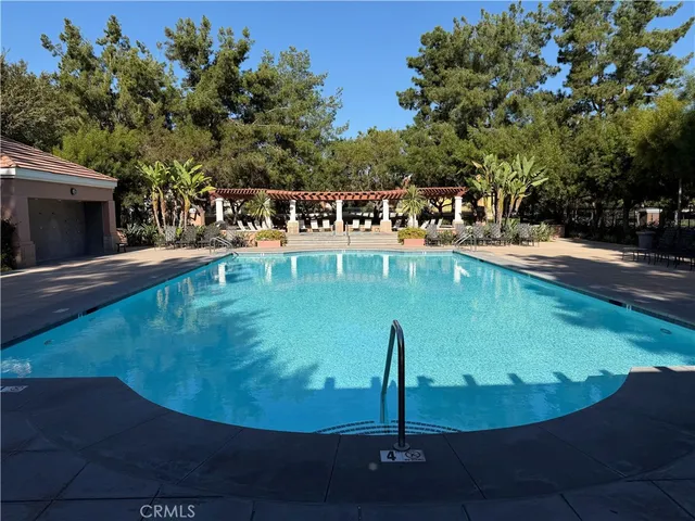 a view of a swimming pool with outdoor seating