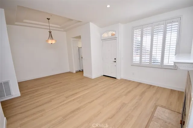 a view of a room with wooden floor and windows