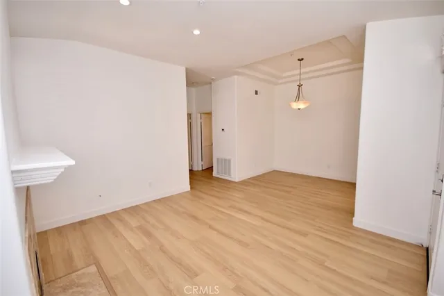 a view of a room with wooden floor