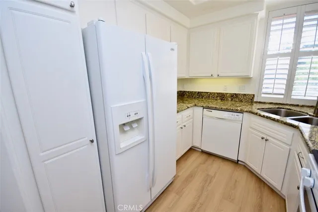 a white refrigerator freezer sitting inside of a kitchen