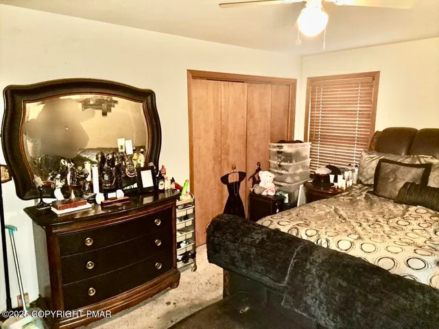 a living room with furniture and a mirror