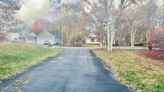 a front view of a house with a yard and pathway