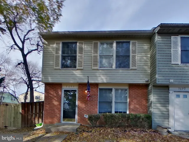 a front view of a house with a tree