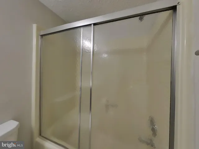 a bathroom with a glass shower door