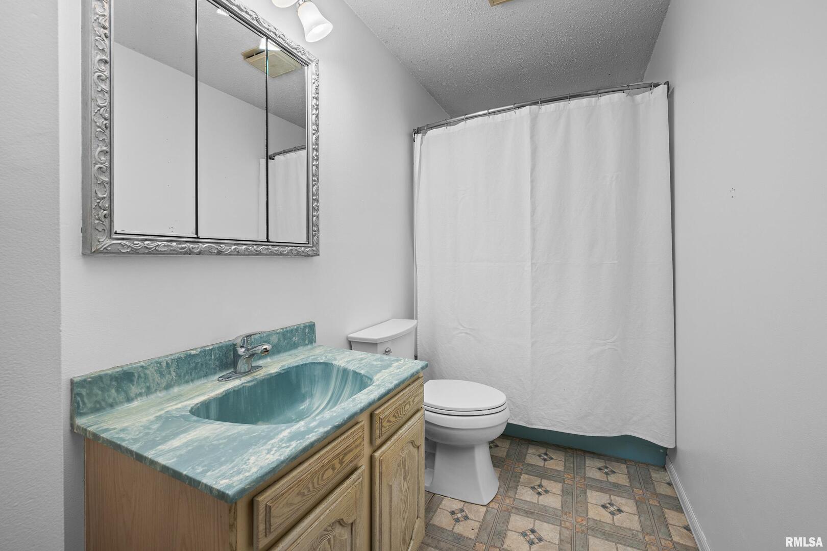 617 6th Street Camanche, IA 52730 - Photo 12 of 25 a bathroom with a sink toilet and vanity