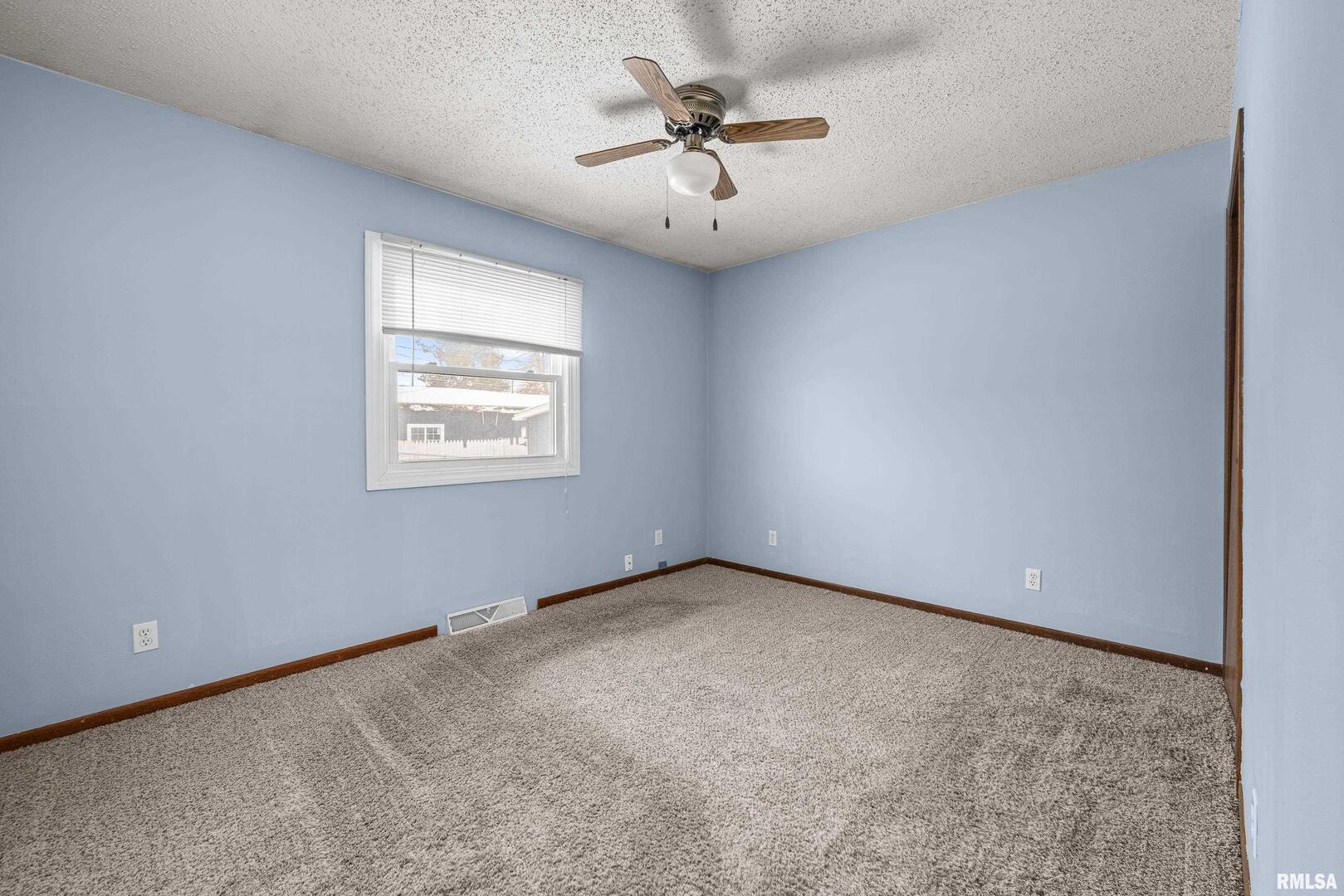 617 6th Street Camanche, IA 52730 - Photo 15 of 25 an empty room with windows and fan