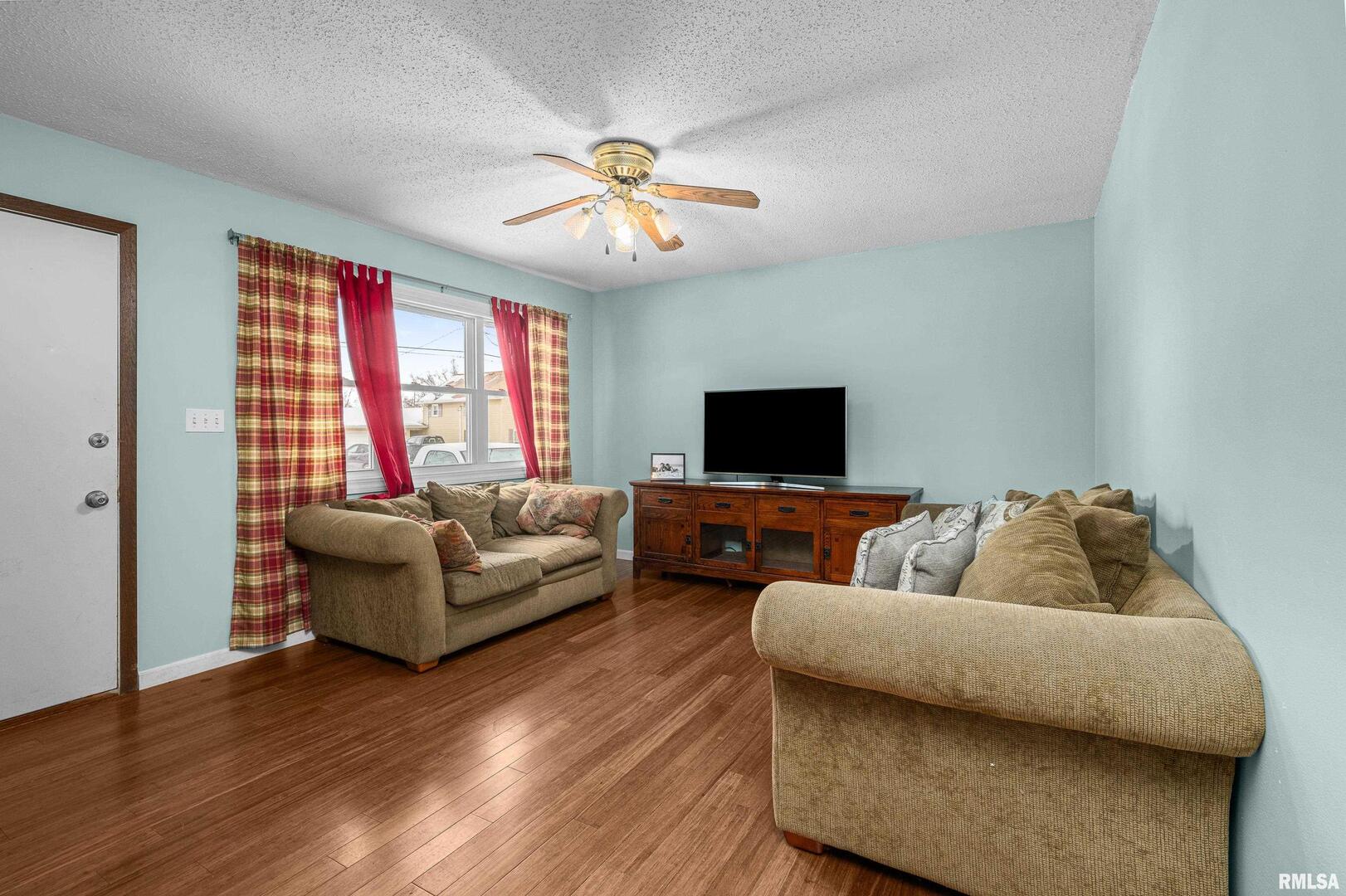 617 6th Street Camanche, IA 52730 - Photo 3 of 25 a living room with furniture and a flat screen tv