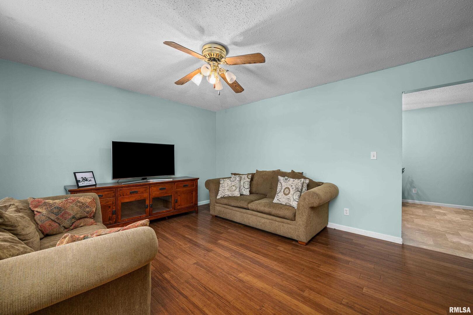 617 6th Street Camanche, IA 52730 - Photo 5 of 25 a living room with furniture and a flat screen tv